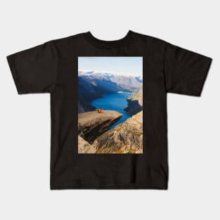 Man sitting on Trolltunga rock meditating Kids T-Shirt